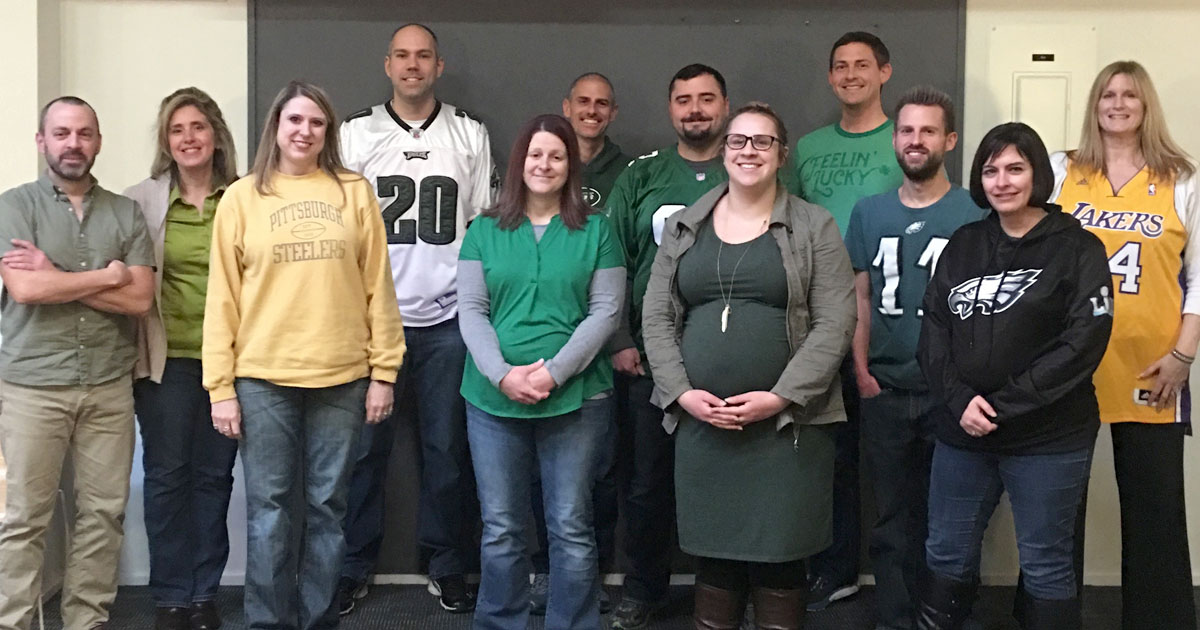 group of employees standing together for an event photo
