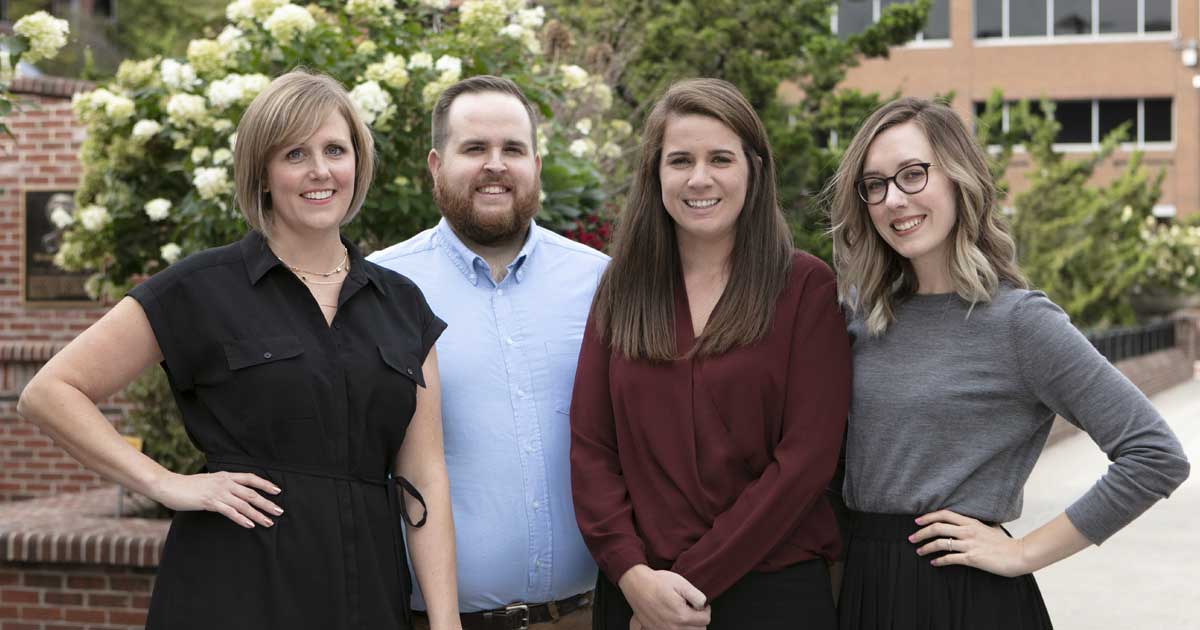 Four Godfrey employees standing