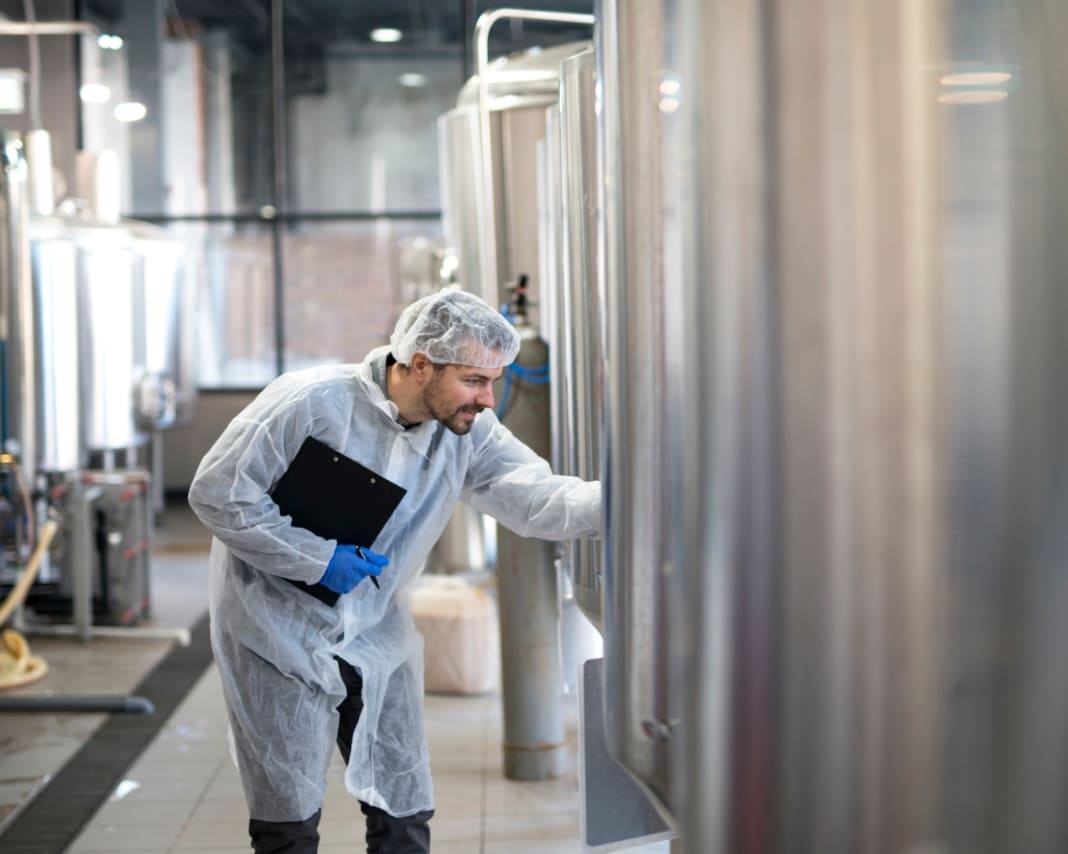 Chemical technician monitoring chemical tanks