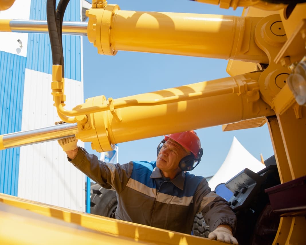 Maintenance worker working on heavy equipment