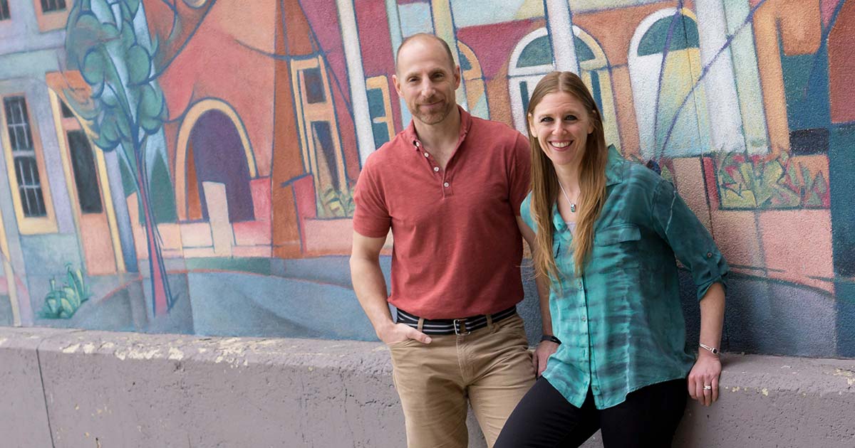 Employees in front of graffiti wall