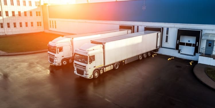 Tractor trailers backed up to loading docks grid image