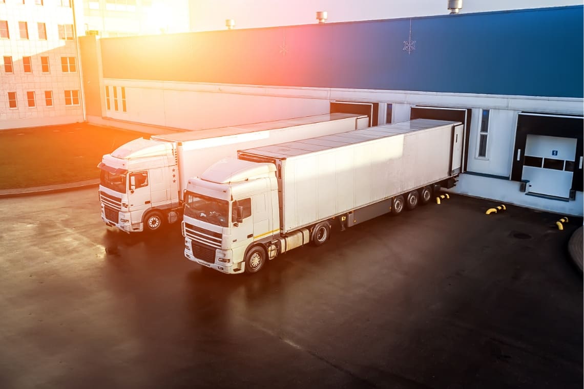 Tractor trailers backed up to loading docks hero image