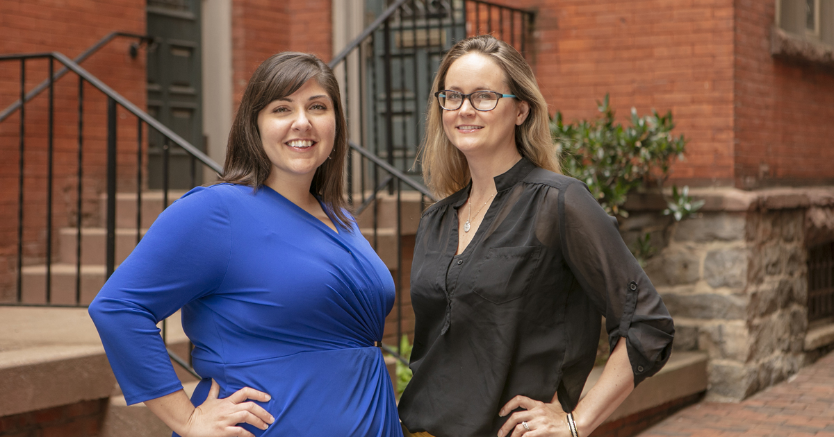 Two women with hands on hip