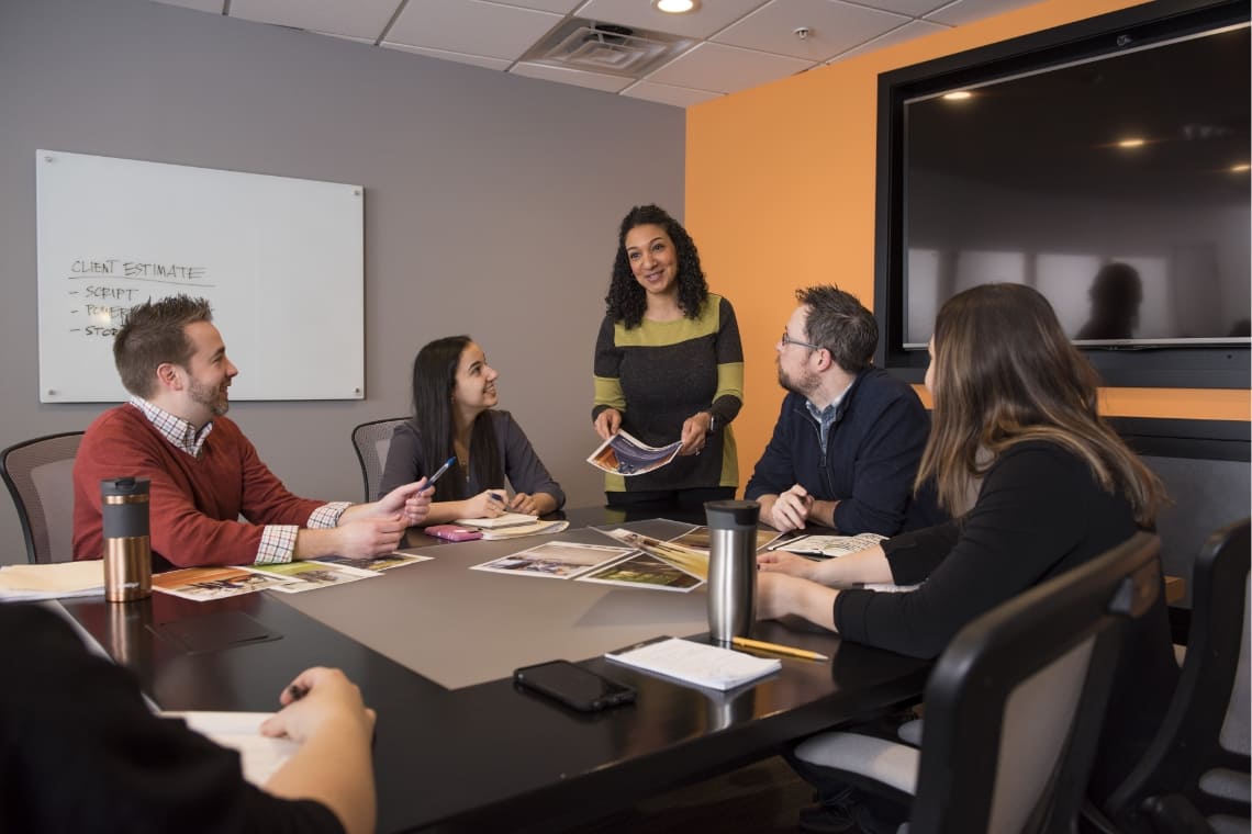 Group of coworkers discussing a project in conference room