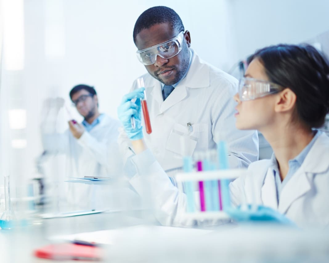 Scientists looking at test tubes