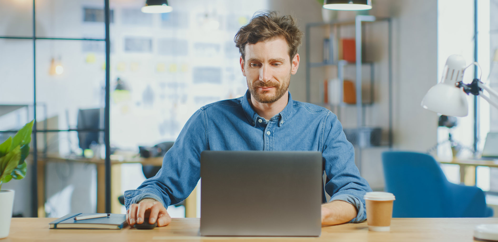 Man sitting at desk with laptop on an office.