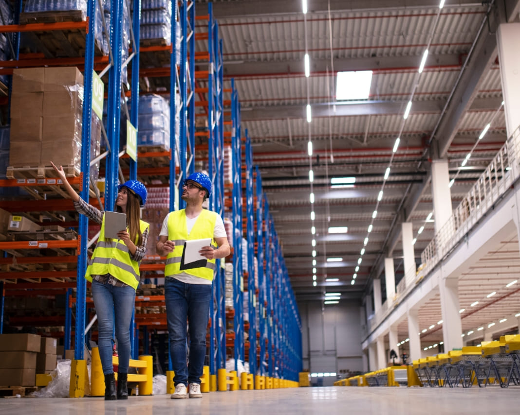 Two workers checking product in warehouse