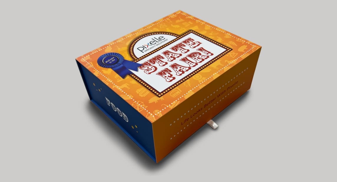 Orange and blue Pixelle Specialty Solutions “State Fair” gift box features a prize ribbon and fair-inspired graphics.