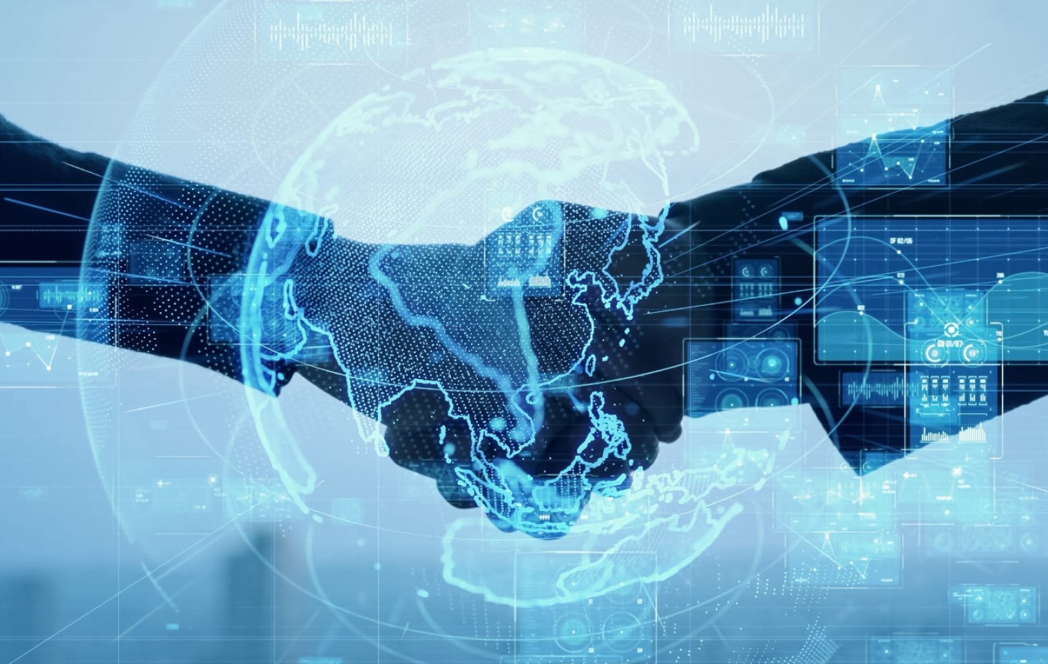Two professionals shake hands beneath a digital globe and data graphics, symbolizing global business partnerships and digital connectivity.