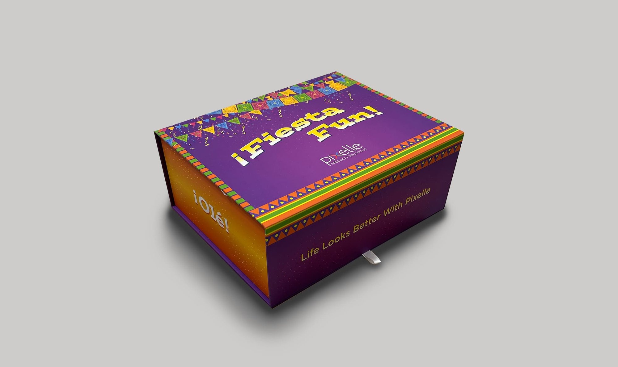 Purple Pixelle Specialty Solutions “¡Fiesta Fun!” gift box features colorful papel picado-inspired patterns and festive detailing.