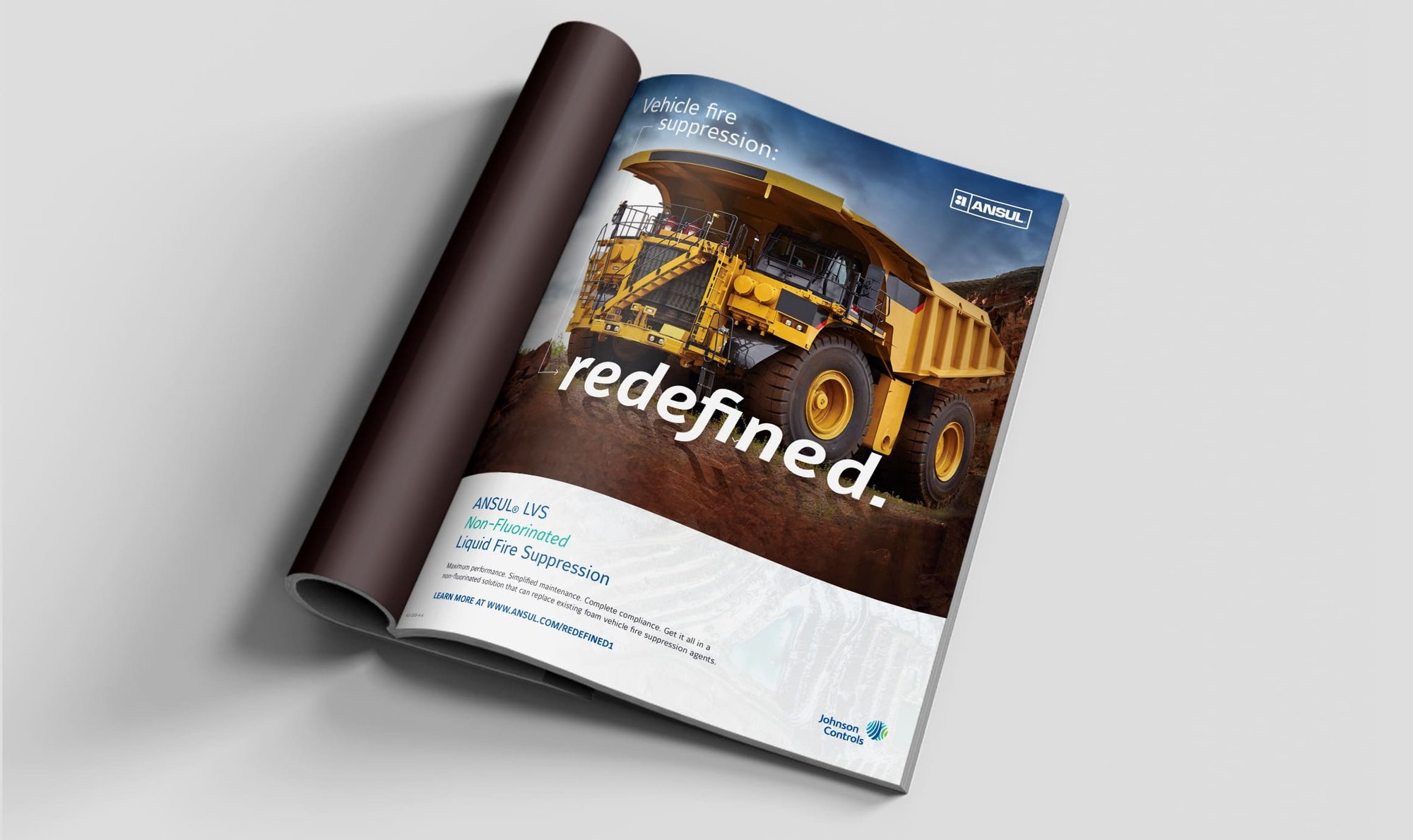 ANSUL magazine ad features a mining haul truck and non-fluorinated vehicle fire suppression messaging.