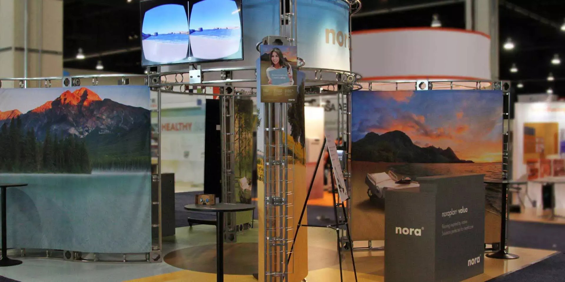 nora trade show booth for noraplan valua features immersive nature imagery and healthcare scenes at the Healthcare Design Expo.