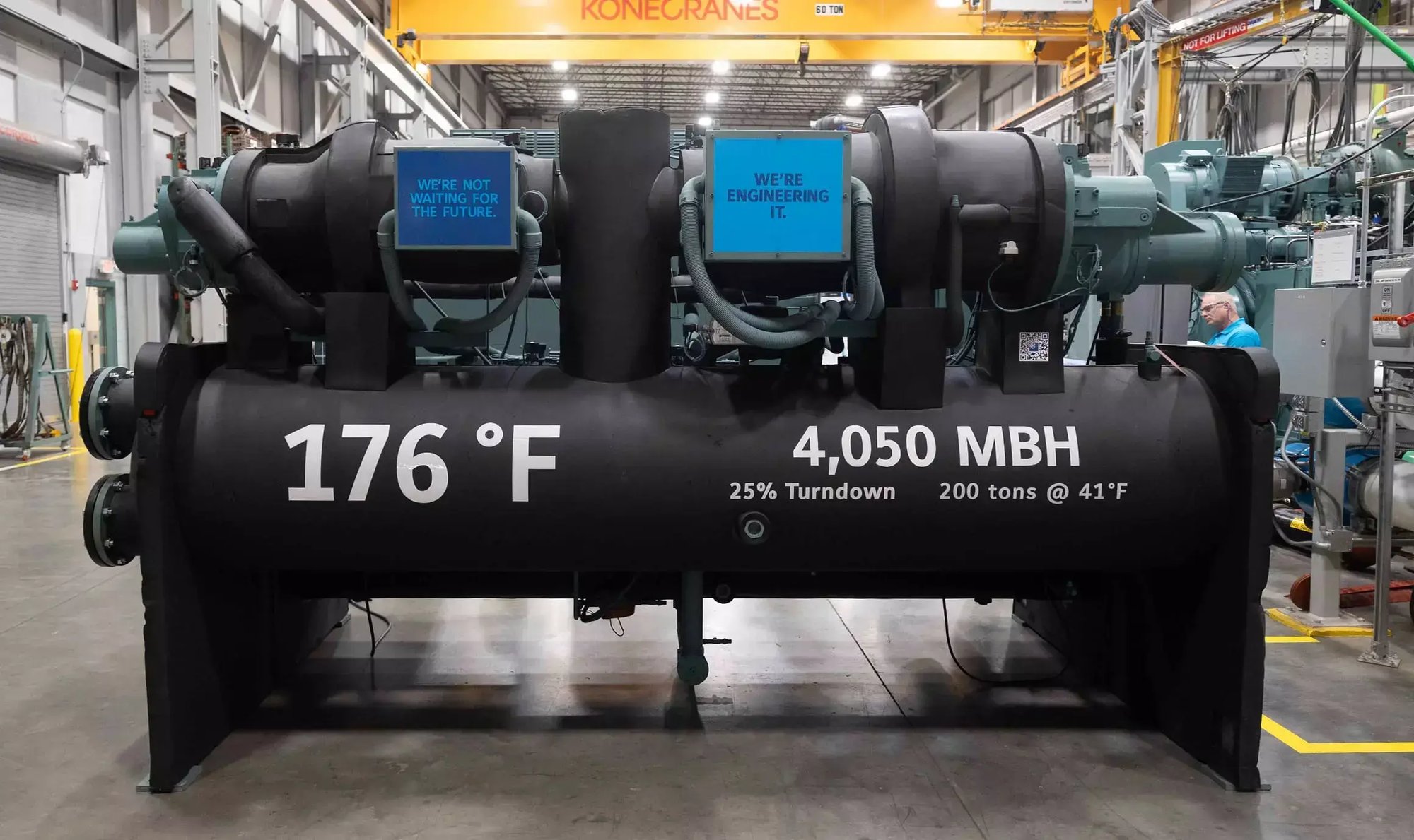 Carousel1Large YORK chiller test unit at the Johnson Controls JADEC facility features performance data and signs highlighting engineering innovation.