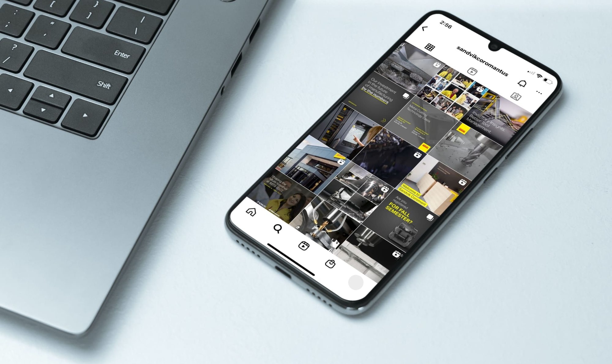 Smartphone beside a laptop displays the Sandvik Coromant Instagram grid featuring manufacturing, tools, people and company content.