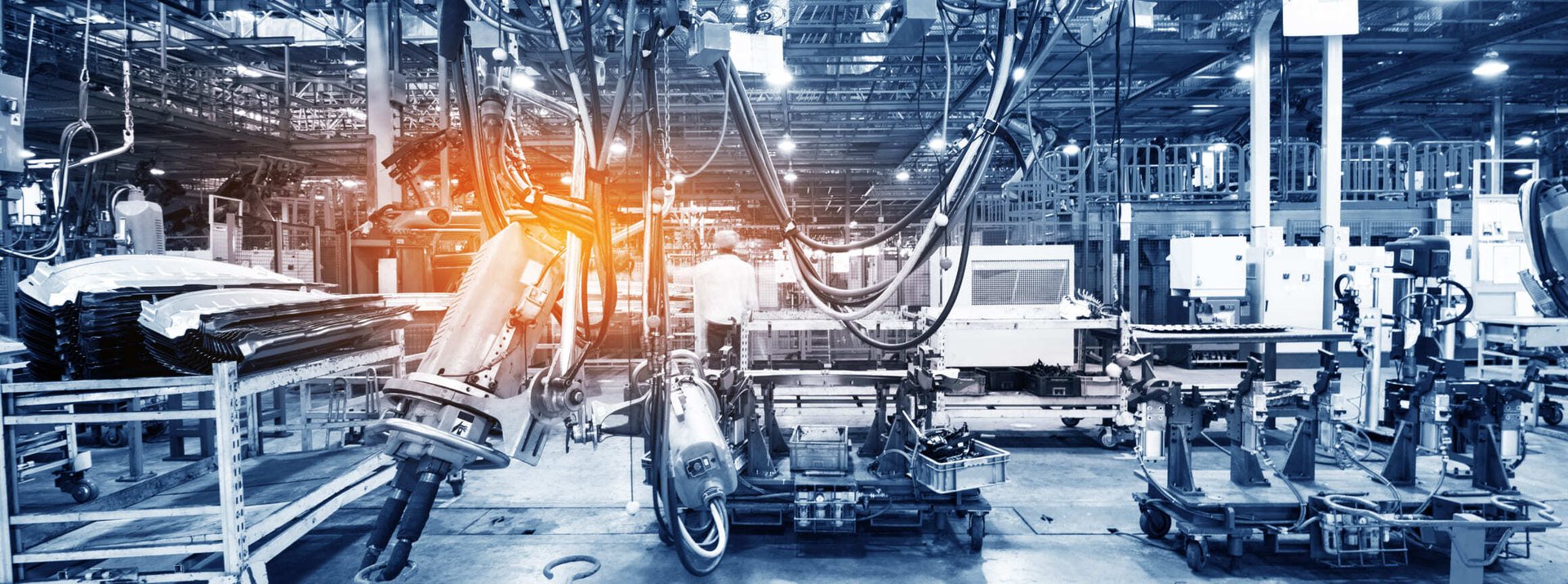 Automated factory floor features robotic equipment, machinery and production systems inside a manufacturing facility.
