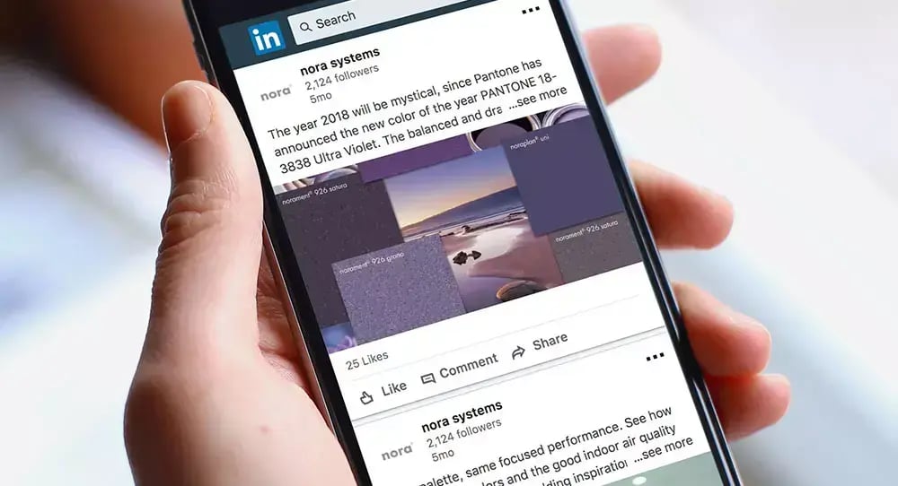 Smartphone displaying a nora systems LinkedIn post featuring colorful rubber flooring products and design inspiration for followers.
