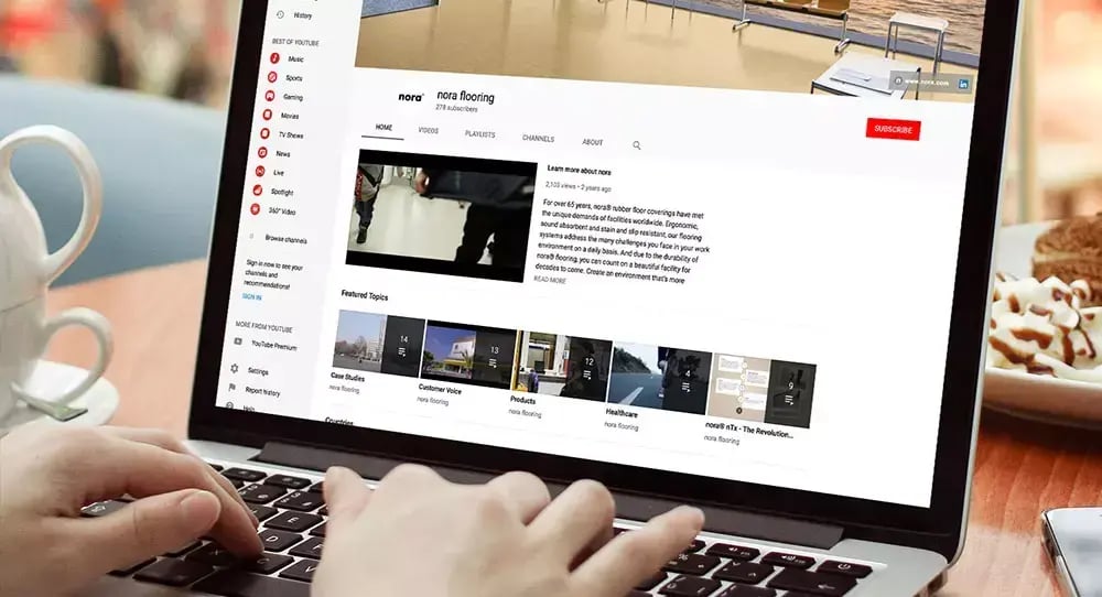 Laptop displaying the nora flooring YouTube channel with videos, case studies and product content designed to engage online audiences.