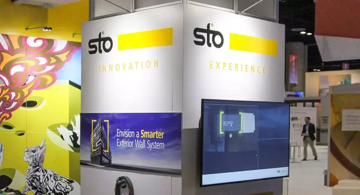 Sto trade show display features a monitor demonstrating an interactive mixed reality experience for exploring an advanced exterior wall system.