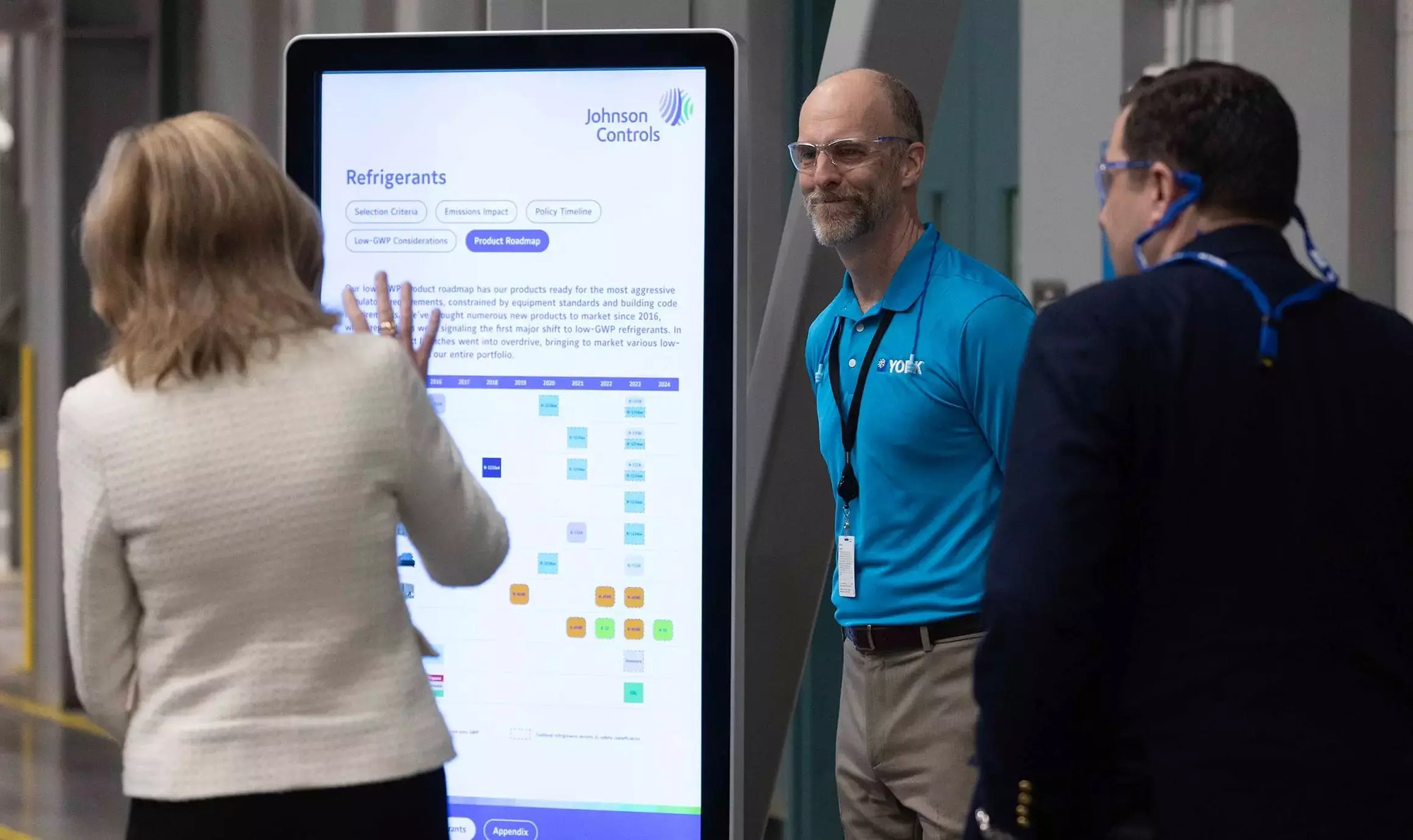 Visitors review a Johnson Controls refrigerants product roadmap on an interactive display with a YORK employee at the JADEC facility.