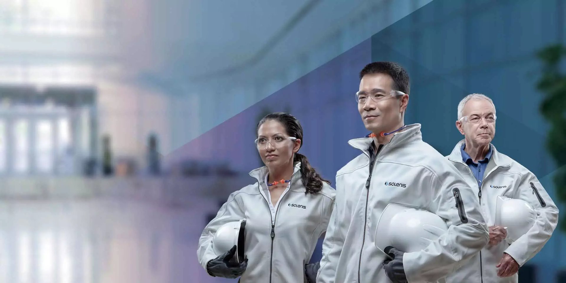 Three Solenis team members in branded uniforms and safety glasses stand together, representing the company’s advanced problem-solving team.