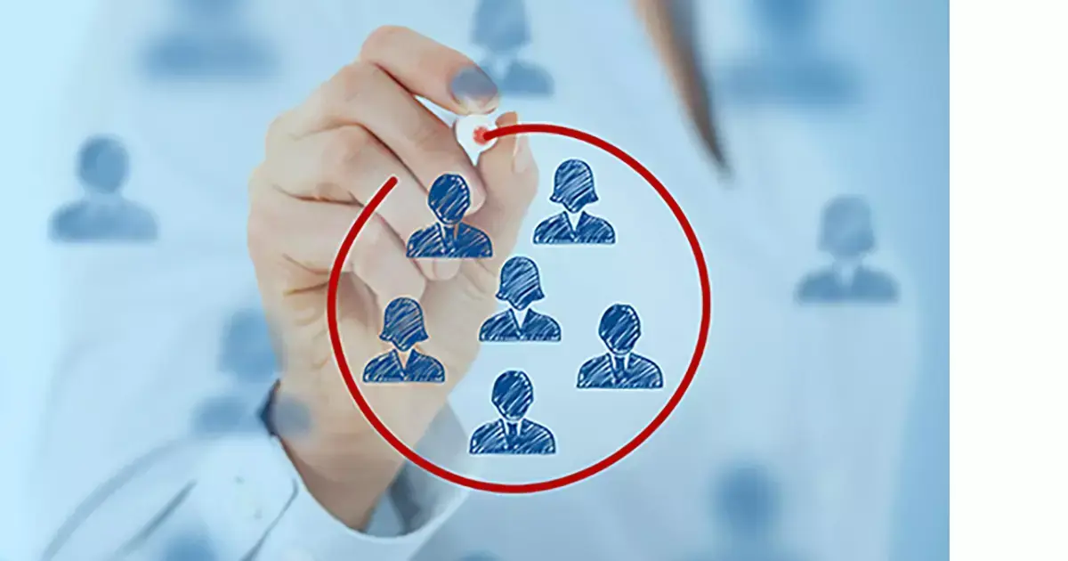 Woman drawing people in a red circle.